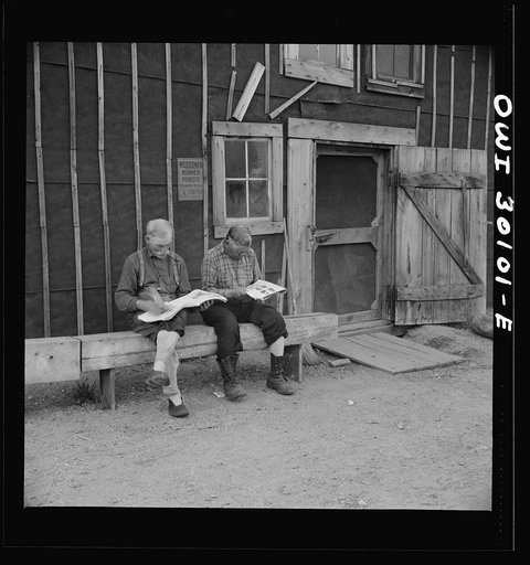 Spring pulpwood drive on the Brown Company timber holdings in Maine. Woodsmen taking it easy in front of the bunkhouse before dinner