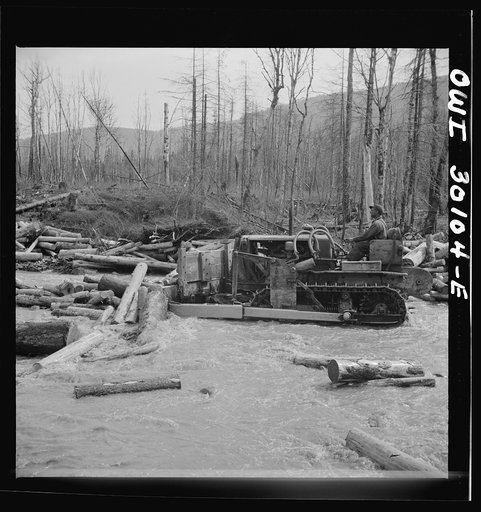 Spring pulpwood drive on the Brown Company timber holdings in Maine. Bulldozer clearing a channel in Dennison Bog Brook so that another jam will not form