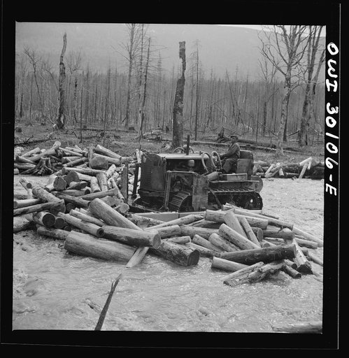 Spring pulpwood drive on the Brown Company timber holdings in Maine. Bulldozer clearing a channel in Dennison Bog Brook so that another jam will not form