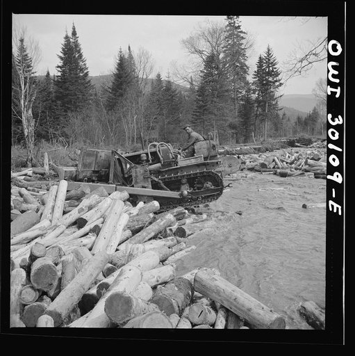 Spring pulpwood drive on the Brown Company timber holdings in Maine. Bulldozer clearing a channel in Dennison Bog Brook so that another jam will not form