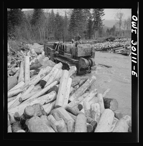 Spring pulpwood drive on the Brown Company timber holdings in Maine. Bulldozer clearing a channel in Dennison Bog Brook so that another jam will not form