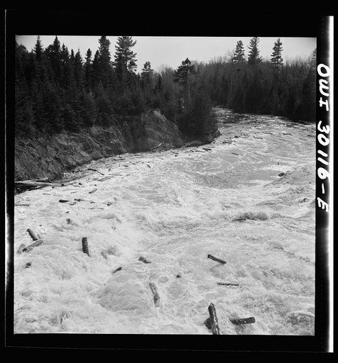 Untitled photo, possibly related to: Spring pulpwood drive on the Brown Company timber holdings in Maine. Wood riding the rapids below the power dam in Kennebago River