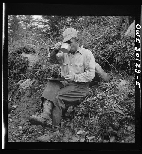 Spring pulpwood drive on the Brown Company timber holdings in Maine. The woodsman's tin bowl may be filled with coffee, strong tea, milk or water at mid-morning or mid-afternoon lunch by the side of the road near where the men are working