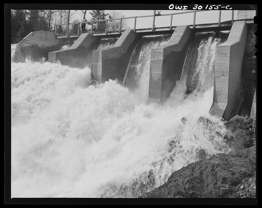 Spring pulpwood drive on Brown Company timber holdings in Maine. Wood sluicing through the power dam, Kennebago River