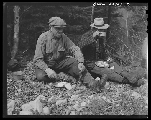 Spring pulpwood drive on the Brown Company timber holdings in Maine. Mid-morning or mid-afternoon lunch by the side of the road, near where the woodsmen are working