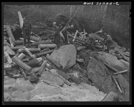 Untitled photo, possibly related to: Spring pulpwood drive on the Brown Company timber holdings in Maine. Woodsmen with picks "putting in rears," moving into the stream bed logs that have been left behind after a "head" has passed