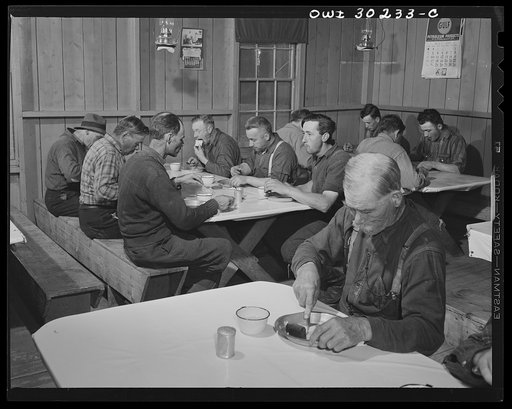 Spring pulpwood drive on the Brown Company timber holdings in Maine. Woodsmen start the day with breakfast at 6:00. Typical menu includes: hot cakes, syrup, baked beans, scrambled eggs, bacon, fried potatoes, biscuits, molasses cookies, gingerbread, pie, coffee, bread and butter