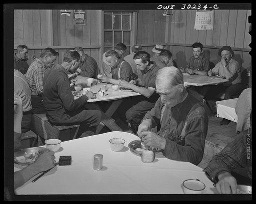 Spring pulpwood drive on the Brown Company timber holdings in Maine. Woodsmen start the day with breakfast at 6:00. Typical menu includes: hot cakes, syrup, baked beans, scrambled eggs, bacon, fried potatoes, biscuits, molasses cookies, gingerbread, pie, coffee, bread and butter