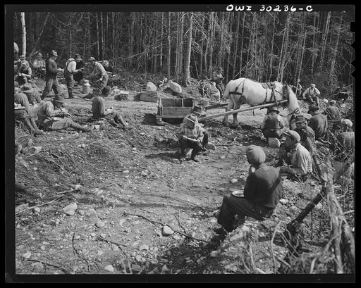 Spring pulpwood drive on the Brown Company timber holdings in Maine. A "mogee" brings lunch when men are working far from passable wagon or truck roads. "Mogee" is French-Canadian mildly profane slang for this horse drawn wheel-less wagon and various other non-descript things; the American equivalen