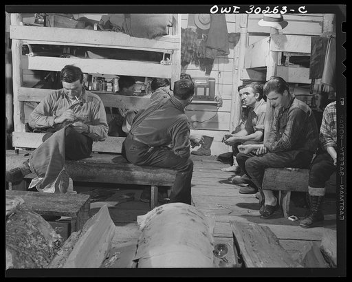 Spring pulpwood drive on the Brown Company timber holdings in Maine. During the evening in the bunkhouse, the woodsmen can hear the news, mend ripped pants, rest their feet after thirteen hours in wet or stiff working boots