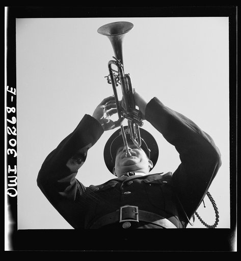 Gloucester, Massachusetts. Memorial Day, 1943. A Legionaire sounding taps for the War dead during services