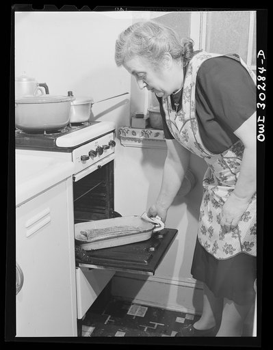 Untitled photo, possibly related to: New York, New York. Mrs. Rose Carrendeno reading letters from her three sons who are in the armed service