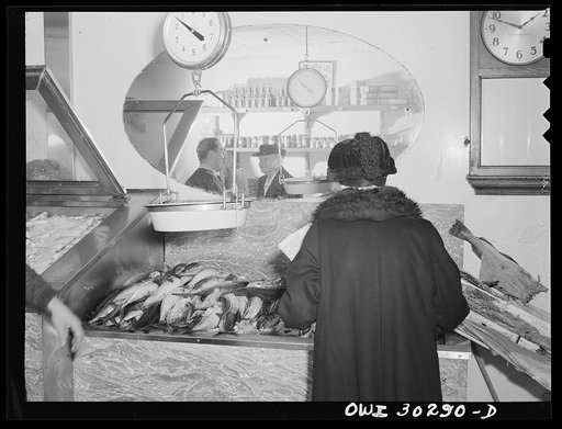 New York, New York. Elderly lady looking for fish at the DeMartino's market