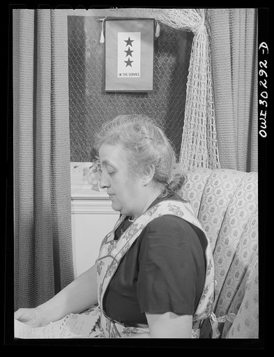 New York, New York. Mrs. Rose Carrendeno reading letters from her three sons who are in the armed services