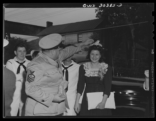 Chief Hawman, boatswain, pouring rice over newlywed coast guardsman's wife