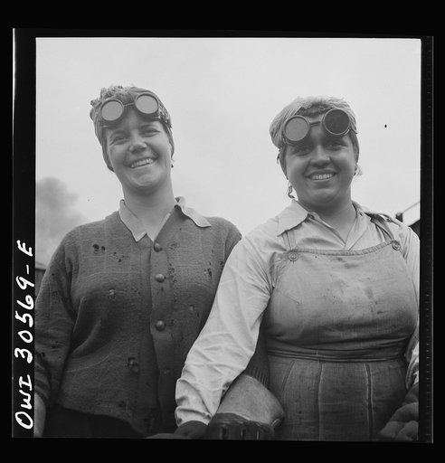 Pitcairn, Pennsylvania. Miss Helen Gusmerotti, twenty-nine, and Miss Mary Mignogna, employed as car repairmen's helpers at the steel car shop in the Pennsylvania Railroad yards, earning seventy-two cents per hour. The two are burning holes in the hopper car sides