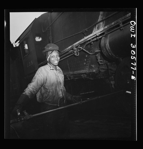 Pitcairn, Pennsylvania. Mrs. Bernice Stevens of Braddock, Pennsylvania, mother of one child, employed in the engine house of the Pennsylvania Railroad, earns fifty-eight cents per hour. She is cleaning a locomotive with a high pressure nozzle. Mrs. Stevens' husband is in the U.S. Army