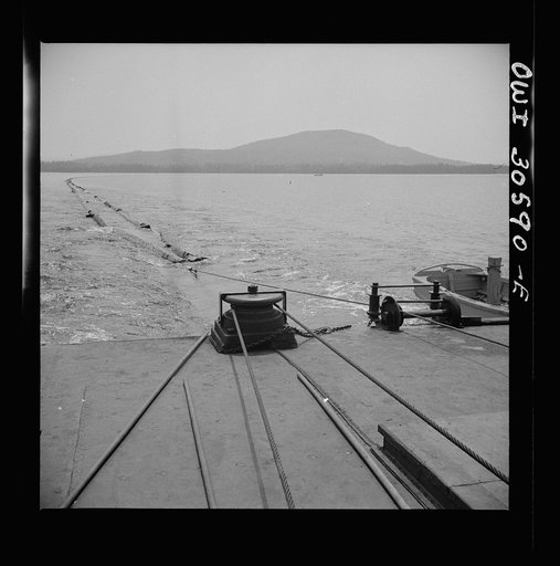 Untitled photo, possibly related to: Spring pulpwood drive on the Brown Company timber holdings in Maine. On its return trip up Mooselookmeguntic Lake, the steamer tows an empty boom to be refilled for the next day's load