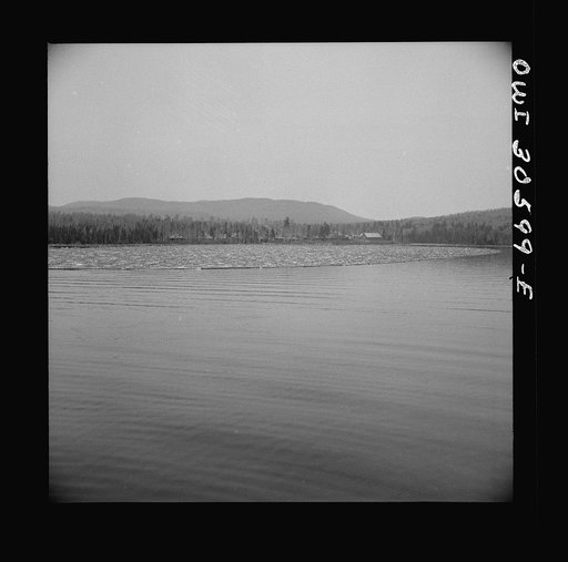 Untitled photo, possibly related to: Spring pulpwood drive on the Brown Company timber holdings in Maine. The safety boom is anchored in a cove where it will not be in the way while the steamer is picking up the full boom
