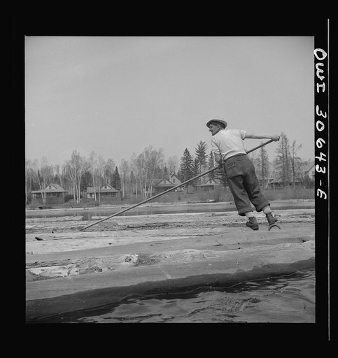 Spring pulpwood drive on the Brown Company timber holdings in Maine. Opening up an empty boom at the upper end of Mooselookmeguntic Lake so it can be filled with more logs from the Kennebago River