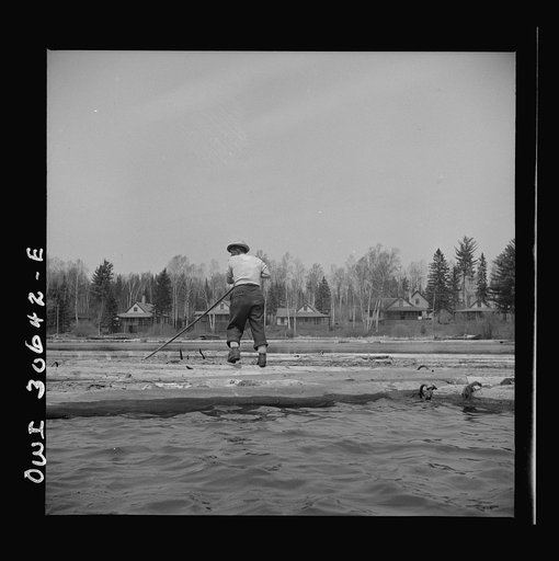 Spring pulpwood drive on the Brown Company timber holdings in Maine. Opening up an empty boom at the upper end of Mooselookmeguntic Lake so it can be filled with more logs from the Kennebago River