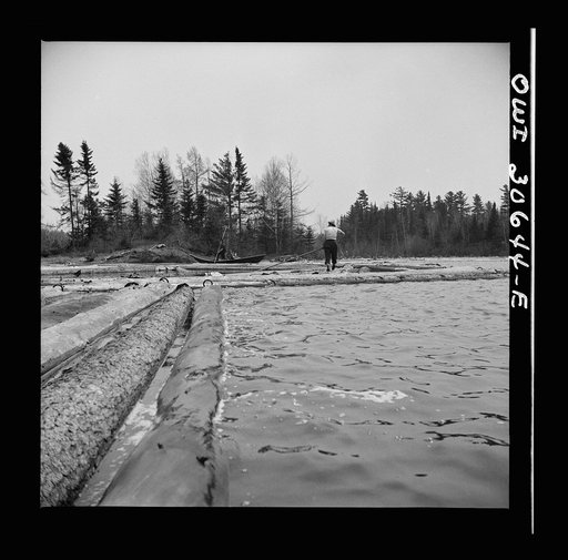 Spring pulpwood drive on the Brown Company timber holdings in Maine. Opening up an empty boom at the upper end of Mooselookmeguntic Lake so it can be filled with more logs from the Kennebago River