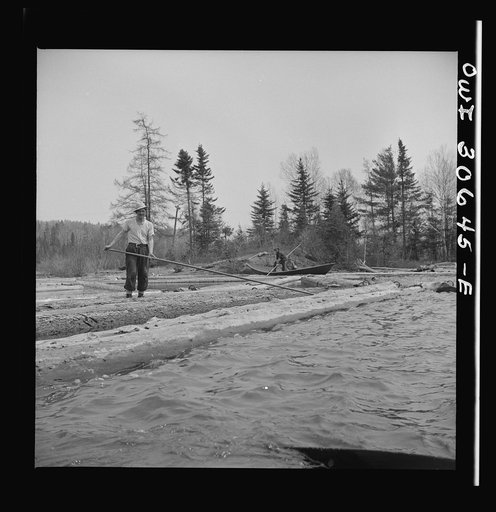 Spring pulpwood drive on the Brown Company timber holdings in Maine. Opening up an empty boom at the upper end of Mooselookmeguntic Lake so it can be filled with more logs from the Kennebago River