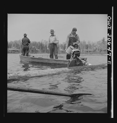 Spring pulpwood drive on the Brown Company timber holdings in Maine. Refueling a motorboat used to open an empty boom at the upper end of Mooselookmeguntic Lake so that it can be filled with more logs from the Kennebago River