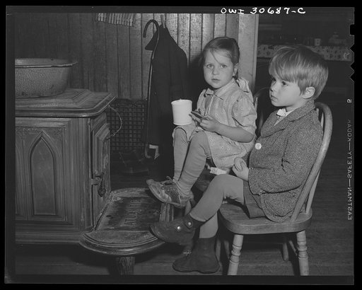 Untitled photo, possibly related to: Buffalo Hill, Aroostook County, Maine. Youngest members of congregation trying to keep warm while eating cold refreshments served in the social period after a Congregational church service in a one-room school house