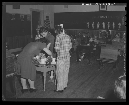 Untitled photo, possibly related to: Buffalo Hill, Aroostook County, Maine. Farm woman dishing out homemade wild strawberry ice cream, one of the refreshments served in the social period after Congregational church service in a one-room schoolhouse