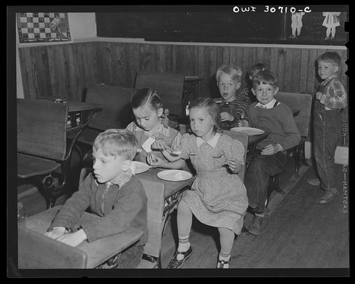 Buffalo Hill, Aroostook County, Maine. Younger members of the congregation eat cookies, flavorade and homemade wild strawberry ice cream, refreshments served in the social period following a Congregational church service held in a one-room rural school house