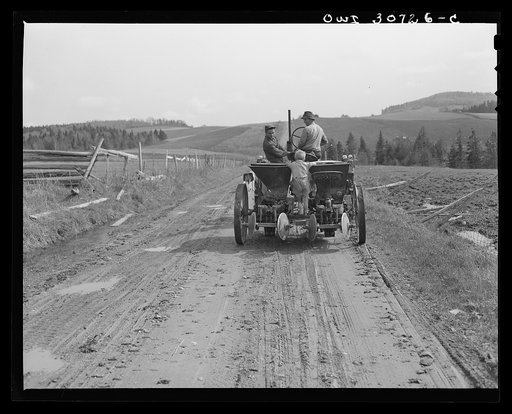 Fort Kent, Aroostook County, Maine. Spring potato planting on the French Acadian farm of Leonard Gagnon. Leonard Gagnon's Ben stealing a ride on the potato planter on the way to the field