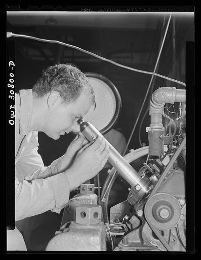 Substitute fuels tested. Emmet L. Reed, laboratory assistant at the U.S. Bureau of Standards, uses a special microscope to measure the degree of wear which substitute gasoline has produced on an automobile engine cylinder