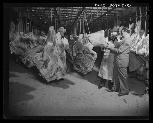 A scene in a wholesale meat market. A reconstruction photographed during the filming of "Black Marketing," a motion picture produced by the U.S. Office of War Information (OWI)