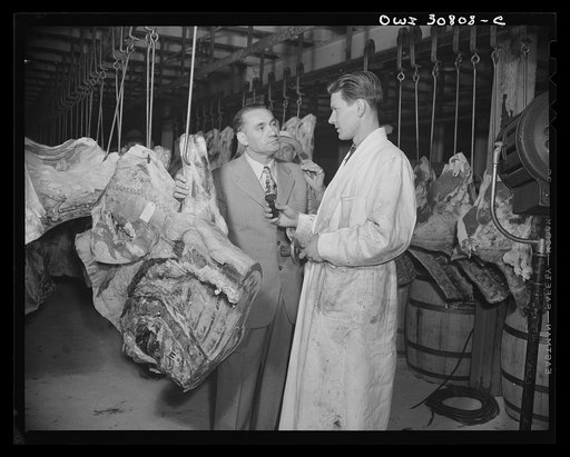 A salesman and a patron in a wholesale meat market. A reconstruction photographed during the filming of "Black Marketing," a motion picture produced by the U.S. Office of War Information (OWI)