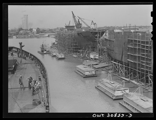 Beaumont, Texas. Cargo vessels under construction at the Pennsylvania shipyards. Welding barges are moored in the foreground