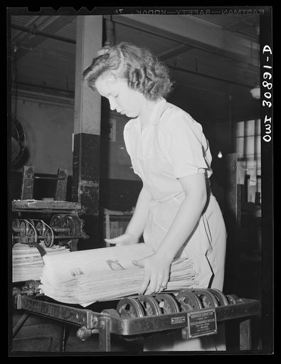 Untitled photo, possibly related to: Beaumont, Texas. Girl preparing newspapers for mailing in bundles in the office of the Beaumont Journal
