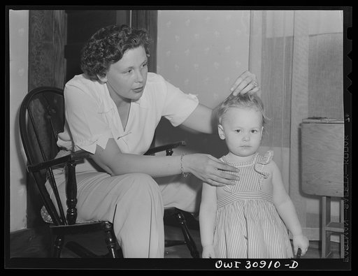 Untitled photo, possibly related to: Beaumont, Texas. Mrs. Elsie McMullen, a laundry truck driver, with her family