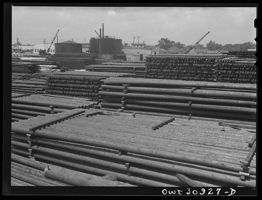 Beaumont, Texas. Treated telephone poles stored in the yard at the International Creosoting Company