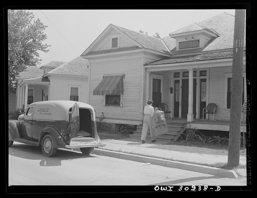 Beaumont, Texas. Elsie McMullen, a laundry truck driver, delivering material which has been drycleaned to a house
