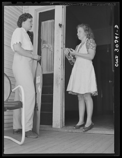 Untitled photo, possibly related to: Beaumont, Texas. Elsie McMullen, a laundry truck driver, delivering material which has been drycleaned to a house