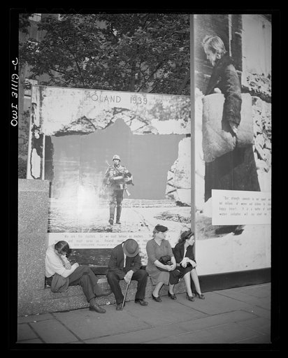 New York, New York. People resting around the Nature of the Enemy exhibition, designed by the OWI (Office of War Information) and installed on the plaza of Rockefeller Center
