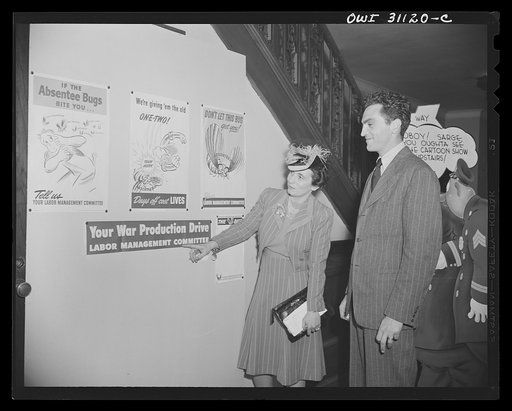 New York, New York. Miss Anna Rosenburg of the War Manpower Commission, and Louis Priscilla, a Chairman of the Committee on War Cartoons of the American Society of Magazine Cartoons, at the exhibition of cartoons concerning lost hours in war production sponsored by the OWI (Office of War Information