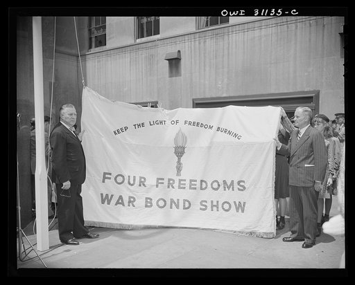 New York, New York. Flag raising ceremony at the Four Freedoms war bond show, on the plaza of the International Building at Rockefeller Center