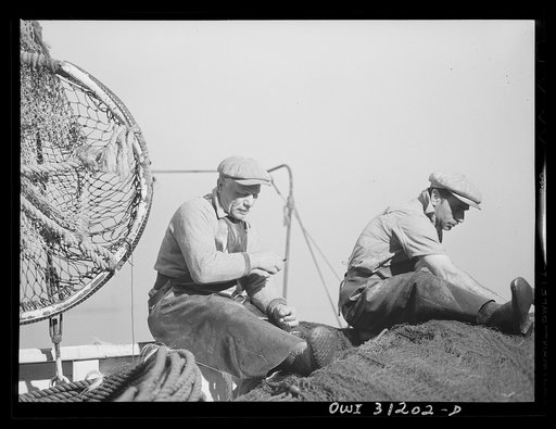 Gloucester, Massachusetts. Antionia Milietello and Vito Cannela of the fishing boat Alden repairing a seining net. These nets cost from seven to ten thousand dollars. Before the war one could be bought for three thousand dollars