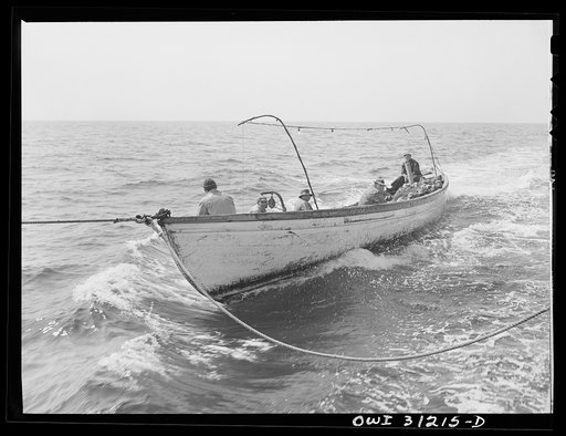 On board the fishing boat Alden, out of Gloucester, Massachusetts. A school of mackerel is sighted and the skipper orders full speed ahead. The big boat speeds up to ten knots, towing the seine boat on the side and a small dory on the rear