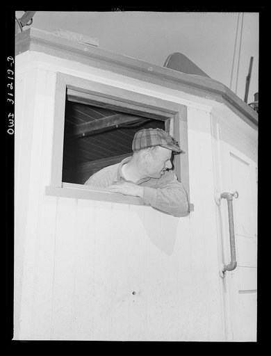 On board the fishing boat Alden, out of Gloucester, Massachusetts. Frank Mineo, Italian captain and owner, in the ship's cabin