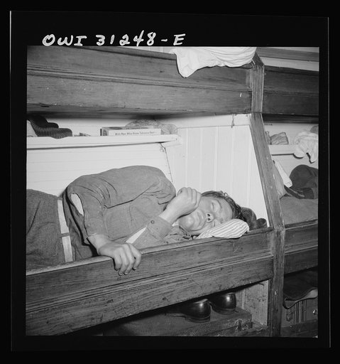 On board the fishing boat Alden, out of Gloucester, Massachusetts. A young fishermen taking a well-deserved rest after twenty-four straight hours of work