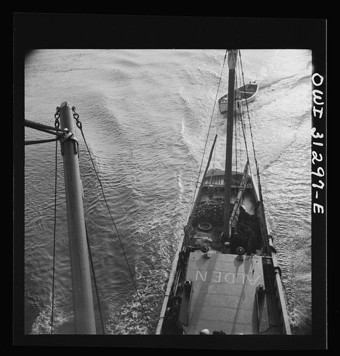 On board the fishing boat Alden out of Gloucester, Massachusetts. A scene at sea showing the mother ship towing a small dory