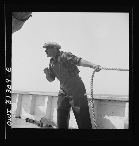 Vito Camella hollers for help to anchor a dory. Glocester, Massachusetts